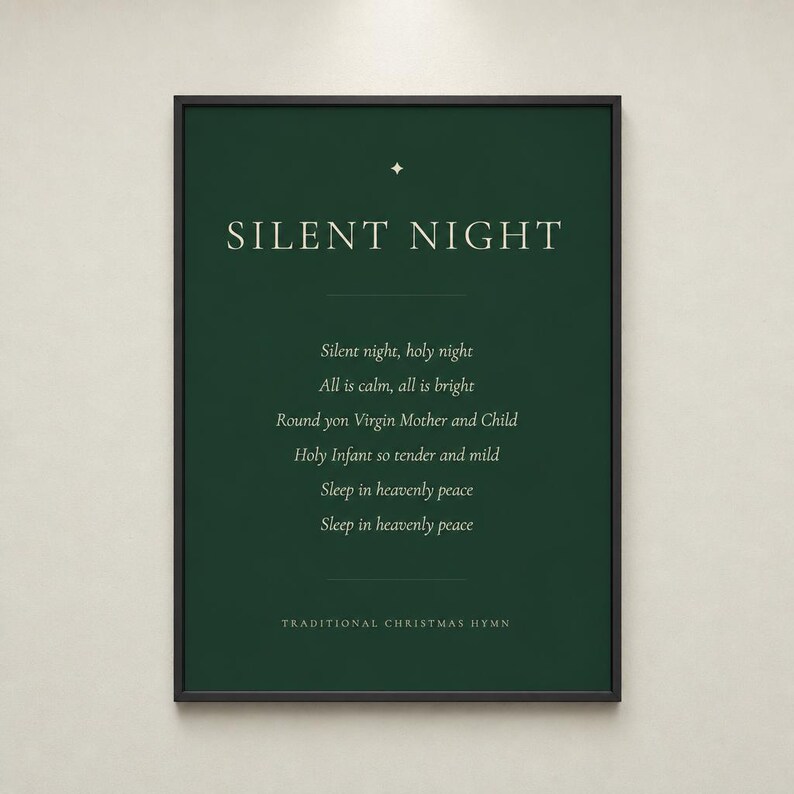 Silent Night Christmas print shown straight on in a slim black frame against a light neutral background. The deep forest green design includes cream serif typography, a gold star ornament, the centered first verse, and a Traditional Christmas Hymn footer. Clean, balanced Christian Christmas decor with the feel of a classic minimalist holiday print.