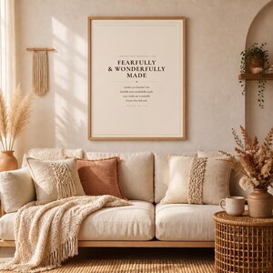 Airy room scene with the framed design above comfortable neutral furniture in a calm, modern Christian home setting. The Fearfully and Wonderfully Made artwork uses minimalist boho typography in beige, brown, and black. This Psalm 139:14 print suits a nursery, baptism gift, baby dedication, bedroom, or quiet Christian reading corner as printable digital wall art.