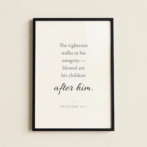 Studio hero shot of Proverbs 20:7 'The Righteous Walks in Integrity' scripture print in slim matte black frame on warm cream limewashed plaster wall, subtle realistic glass reflection. Modern minimalist Christian wall art, instant download, Father's Day gift, men's ministry appreciation, pastor appreciation print.