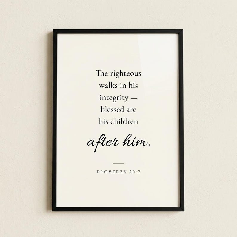 Studio hero shot of Proverbs 20:7 'The Righteous Walks in Integrity' scripture print in slim matte black frame on warm cream limewashed plaster wall, subtle realistic glass reflection. Modern minimalist Christian wall art, instant download, Father's Day gift, men's ministry appreciation, pastor appreciation print.