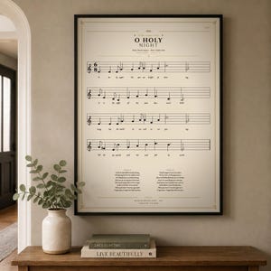 O Holy Night single vintage hymn print in a thin black metal frame, frontal view on an off-white textured wall, modern classical Christmas arrangement with soft top light and gentle shadow. Holiday Christian sheet music wall art digital download from TheFramedVerse, the beloved carol on a cream and antique sepia hymnal page.