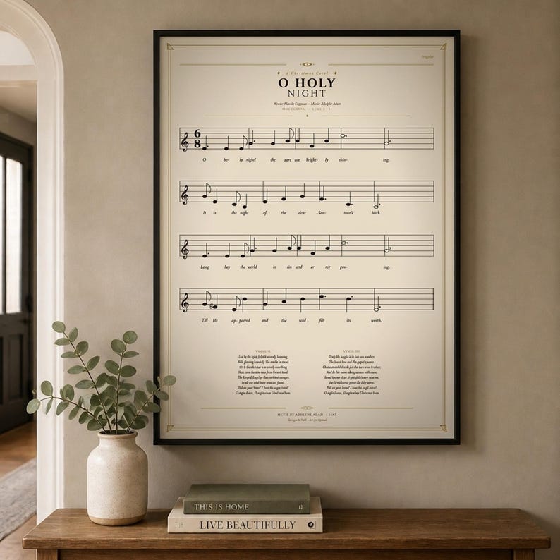O Holy Night single vintage hymn print in a thin black metal frame, frontal view on an off-white textured wall, modern classical Christmas arrangement with soft top light and gentle shadow. Holiday Christian sheet music wall art digital download from TheFramedVerse, the beloved carol on a cream and antique sepia hymnal page.