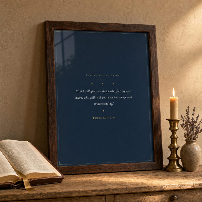 Jeremiah 3:15 scripture print in rustic walnut frame leaning on an oak console beside an open leather Bible and dried lavender stems in earthenware vase, warm editorial pastoral gifts display, thank you pastor christian wall art digital download, pastor church leader appreciation gift by TheFramedVerse