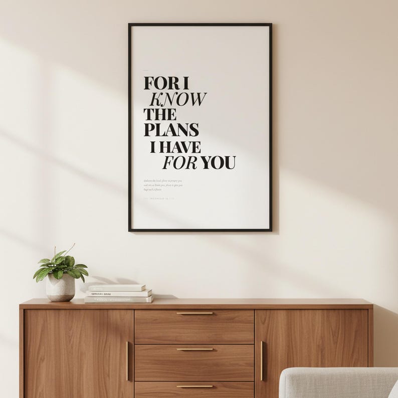 Jeremiah 29:11 Wall Art For I Know the Plans I Have for You Modern Christian, — "For I know the plans I have for you, declares the Lord, plans to prosper you", in contemporary bold serif typography in black on clean white background, displayed in a beautifully styled modern living room above a warm wooden sideboard with soft natural light creating gentle shadows on the frame