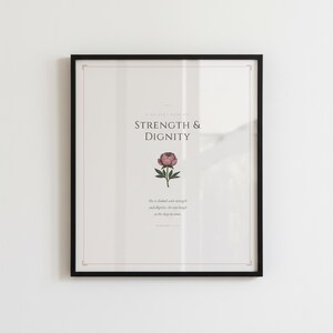 Proverbs 31 25 Mothers Day Print She Is Clothed Strength Dignity Christian Wall, — "She is clothed with strength and dignity, and she laughs without fear of the future", in gentle sage green nursery design with soft botanical watercolor illustration and calming earth tones, showcased in an elegant contemporary home interior with curated decor elements