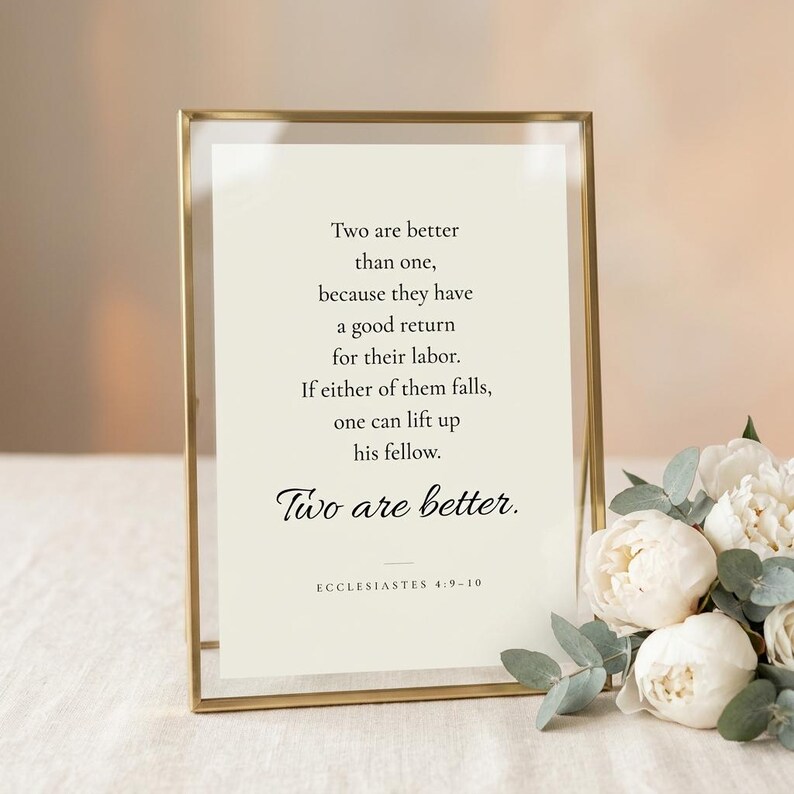 Ecclesiastes 4:9-10 'Two Are Better Than One' wedding scripture print in elegant brass-edged glass float frame with glass reflections, beside white peonies on cream linen. Botanical romantic Christian wedding wall art, newlywed and anniversary print, bridal shower keepsake, instant digital download.