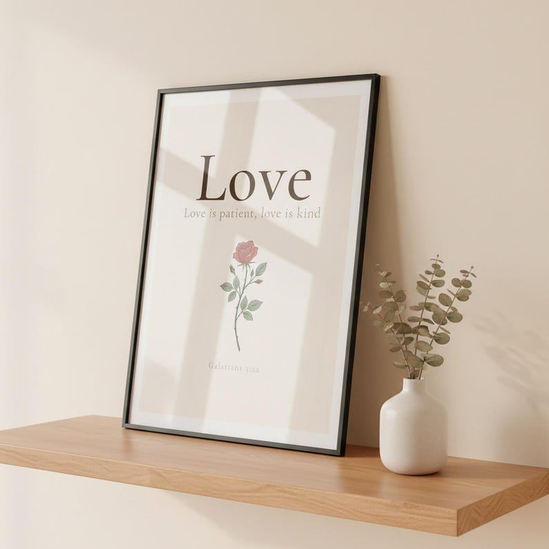 Love Fruit of the Spirit Christian wall art print featuring Galatians 5:22, with beautiful red rose botanical illustration, in minimalist botanical watercolor illustration on warm cream background with elegant serif typography, showcased in an elegant contemporary home interior with curated decor elements, demonstrating how this Christian art piece elevates any living space