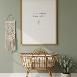 Matthew 19 14 Let the Children Come to Me framed wall art on sage green wall above rattan bassinet with white linens. Macrame decor and eucalyptus. Watercolor cotton flower illustration. Christian nursery printable digital download for baby shower baptism gift.