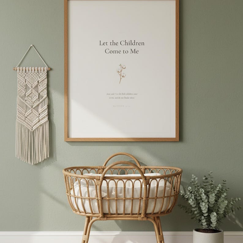 Matthew 19 14 Let the Children Come to Me framed wall art on sage green wall above rattan bassinet with white linens. Macrame decor and eucalyptus. Watercolor cotton flower illustration. Christian nursery printable digital download for baby shower baptism gift.