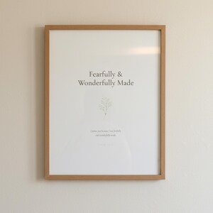 Nursery Bible Verse Wall Art Set of 6 Printable Christian Scripture Prints, in gentle sage green nursery design with soft botanical watercolor illustration and calming earth tones, photographed in beautiful close-up detail showing the premium glass frame reflection, the crisp typography and the intricate artistic details of the design