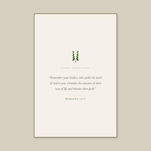 Hebrews 13:7 Remember Your Leaders scripture print framed in rustic walnut, leaning on oak console beside open leather-bound Bible and brass candlestick with lit beeswax candle, dried wheat stems in earthenware vase, warm editorial pastoral gifts display, thank you pastor christian wall art digital download TheFramedVerse