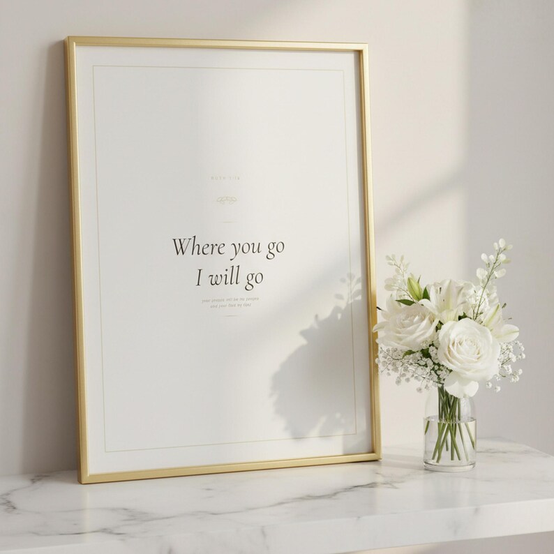 Christian Wedding Wall Art Set of 3 Bible Verse Prints Love Is Patient, in romantic wedding typography with elegant calligraphy, delicate gold ornamental accents on warm blush background, styled on a wooden floating shelf next to a ceramic vase with dried eucalyptus branches and stacked books, creating a warm and inviting Christian home decor vignette