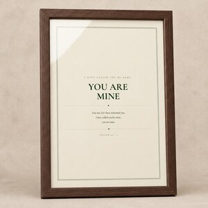 What you get overview showing the design and its four high resolution printable ratios for flexible frame sizes. The You Are Mine artwork features Isaiah 43:1 in minimalist forest green typography on warm beige. This Isaiah 43:1 print suits a nursery, baptism gift, baby dedication, bedroom, or calm Christian reading corner as printable digital wall art.