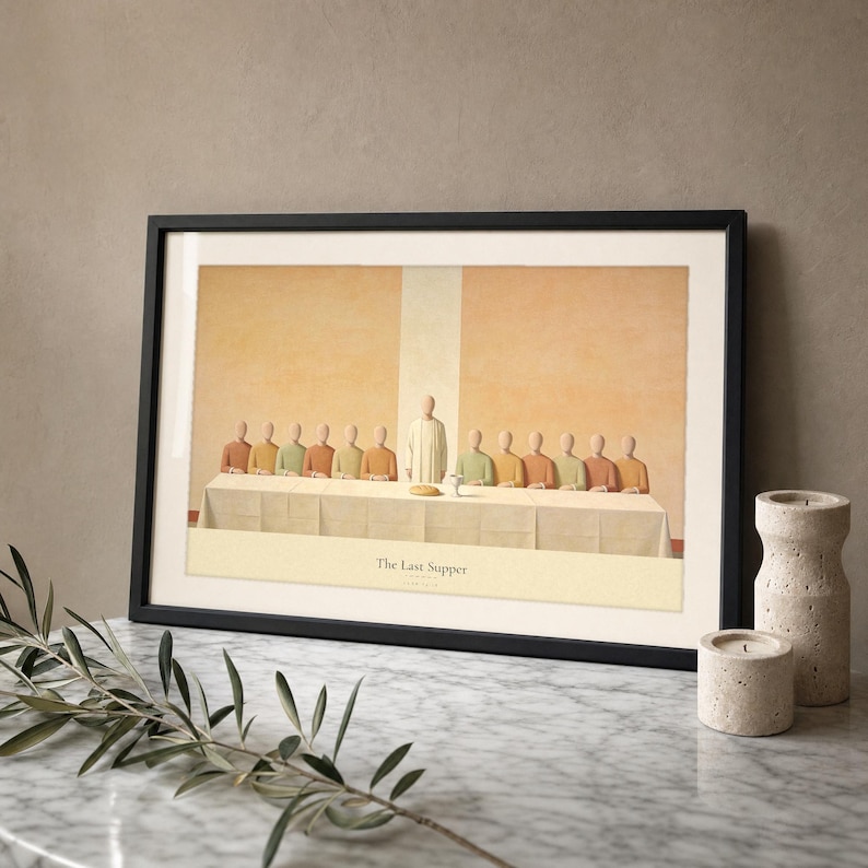 The Last Supper modern Christian print in a thin black frame with a visible glass front, leaning on a Carrara marble surface with a single olive branch casting a soft shadow at the left and two votive candles at the right. Warm beige plaster backdrop, bright morning light and a clean reflection across the glass. Digital download from TheFramedVerse on Etsy.