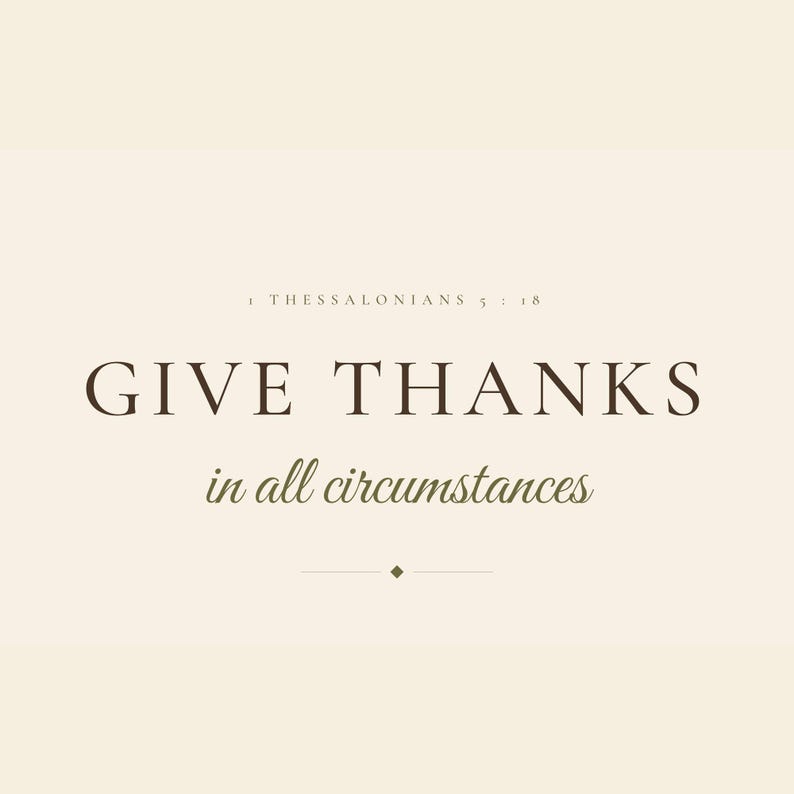 Close-up of the Give Thanks in All Circumstances typography, showing crisp dark brown display serifs and flowing olive script against a warm cream background. The image highlights the restrained capital line, delicate hairline divider, small diamond detail, italic verse body, and ESV caption that give this 1 Thessalonians 5:18 print its refined, faith-centered character.