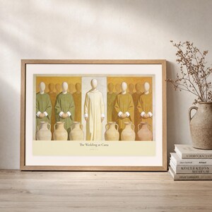 Leaning frame mockup of The Wedding at Cana on a rustic wood console beside stacked art books and a tall ceramic vessel with dried stems. The print shows Christ centered between six complete stone jars, with three on the left and three on the right. The oak frame, broad cream mat, plaster wall, and soft side light create a relaxed display while keeping the title and John 2:7 legible.