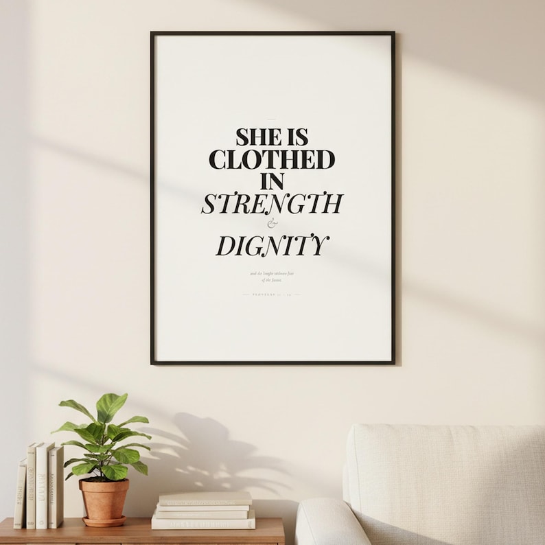 Proverbs 31 25 Wall Art She is Clothed in Strength and Dignity Scripture Print, — "She is clothed with strength and dignity, and she laughs without fear of the future", in elegant Mother's Day design with soft pink watercolor botanical flowers and graceful serif typography. Instant digital download printable wall art in multiple sizes for easy home printing