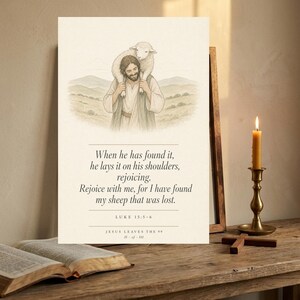 Jesus Leaves the 99 modern minimalist scripture print in rustic walnut frame leaning on a weathered oak console shelf, beside an open leather-bound Bible open to Luke 15, a lit beeswax taper candle, and a small brass cross, warm amber candlelight, editorial christian home decor still life, parable lost sheep digital download from TheFramedVerse