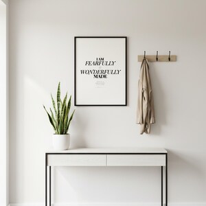 Psalm 139 14 Wall Art Fearfully and Wonderfully Made Scripture Print Nursery, in gentle sage green nursery design with soft botanical watercolor illustration and calming earth tones, displayed in a bright modern entryway next to a coat rack with natural greenery, serving as welcoming faith-filled home decor