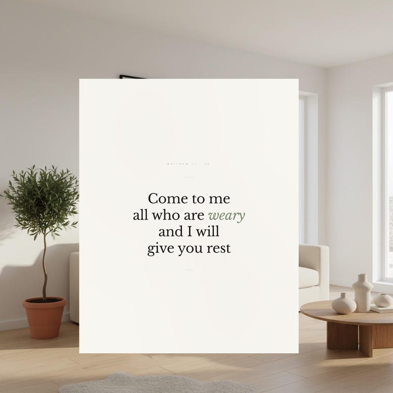 Matthew 11:28 Christian wall art print Come to Me all who are weary and I will give you rest in minimalist serif typography. Displayed in a bright modern living room with an olive tree, white sofa and wood coffee table. Calming scripture decor for a bedroom, entryway or prayer corner. Instant digital download printable.