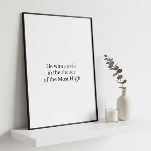 Psalm 91:1 Wall Art He Who Dwells in the Shelter of the Most High Minimalist Scr — close-up detail of typography and paper texture. This modern minimalist christian scripture wall art print features beautiful serif typography on warm cream background. Psalm 91:1 bible verse digital download printable for home office bedroom living room gallery wall decor. Perfect christian gift idea from TheFra...