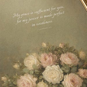 Extreme close-up macro photograph of My Grace Is Sufficient 2 Corinthians 12:9 vintage oil painting print on premium archival matte paper, showing canvas brushstroke texture, ink saturation, crystal-clear Italianno cursive verse typography, antique floral painting detail in tack-sharp focus, TheFramedVerse Christian digital download
