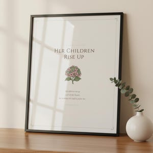 Proverbs 31 28 Mothers Day Print Her Children Rise Up Blessed Christian Wall Art, in gentle sage green nursery design with soft botanical watercolor illustration and calming earth tones, displayed in a bright modern entryway next to a coat rack with natural greenery, serving as welcoming faith-filled home decor