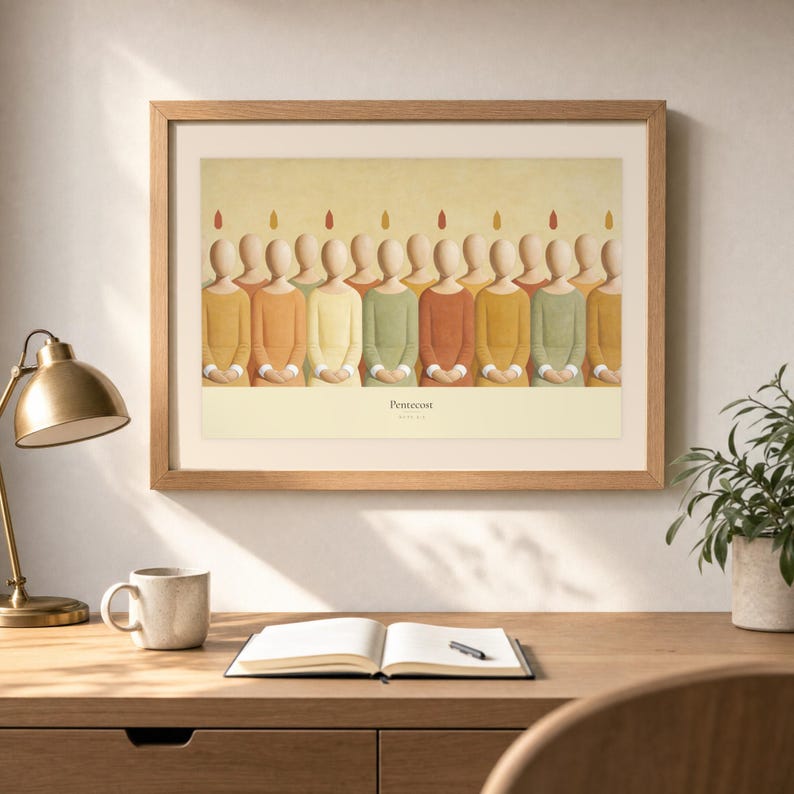 Desk mockup of Pentecost in a light oak frame above a wooden workspace with a brass lamp, ceramic mug, open notebook, pen, and leafy plant. The artwork shows a row of faceless apostles standing shoulder to shoulder, each with a small flame above the head. Angled sunlight, neutral styling, and cream matting place the Bible story print in a quiet study or home office setting.