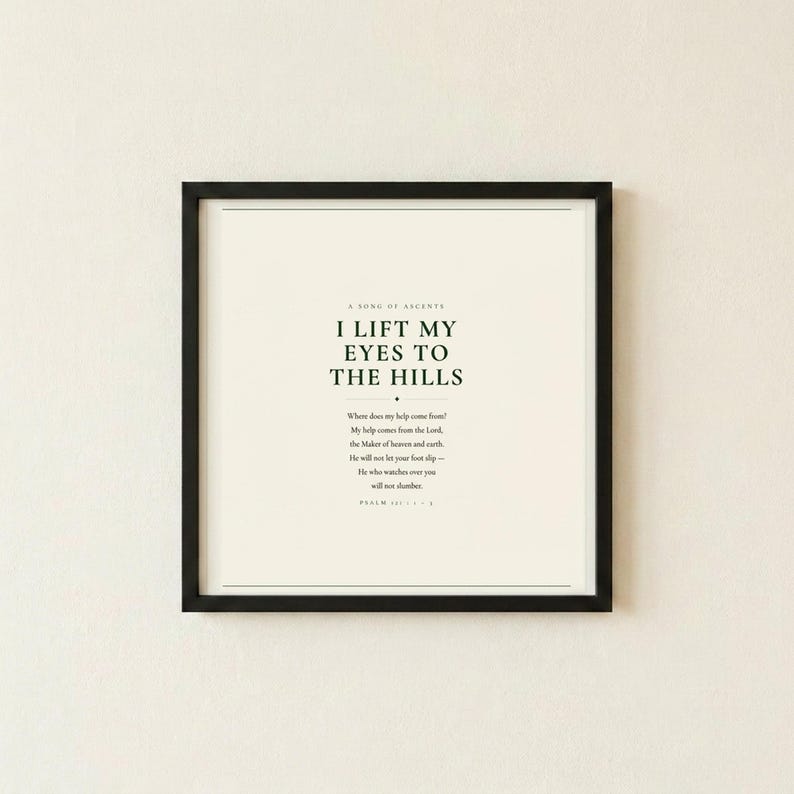 Psalm 121 I Lift My Eyes to the Hills Where Does My Help Come From scripture art print in thin black frame flat mounted on warm cream textured wall, front-facing clean product photo, dark forest green minimalist typography on cream background, christian scripture wall art psalm 121 print baptism housewarming moving gift