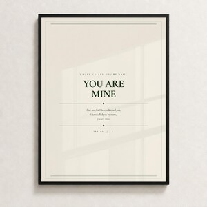 You Are Mine Isaiah 43:1 scripture print minimalist christian baptism gift baby dedication nursery wall art dark forest green typography on warm cream background, front-facing product shot thin black frame cream textured wall soft diffused natural light clean, digital download printable wall art instant download