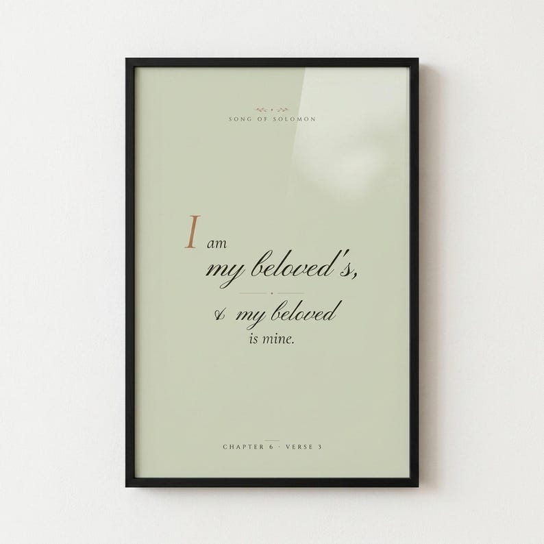 Song of Solomon 6:3 'I Am My Beloved's' coquette sage Christian wedding scripture print in thin gold metal frame, frontal view on warm off-white textured wall, romantic feminine styling with soft top light and gentle shadow below frame, e-commerce hero photograph, instant download from TheFramedVerse
