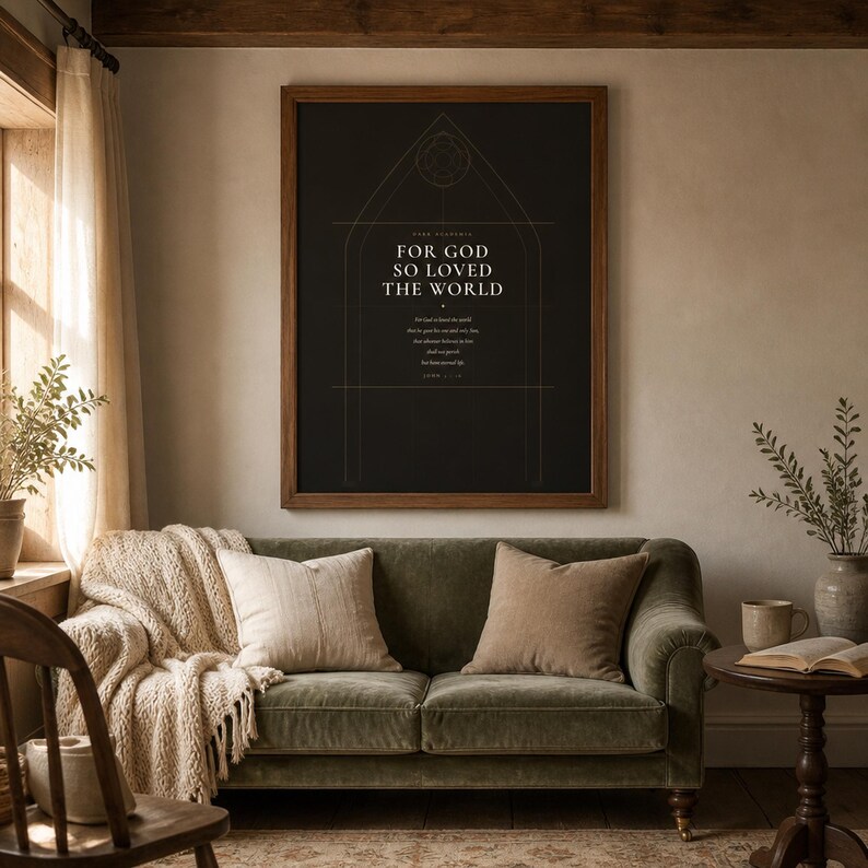 John 3:16 Dark Academia scripture print hanging above a dark leather sofa in moody living room. For God So Loved the World framed art with gothic arch background in walnut frame. Sophisticated Christian wall art printable digital download for bible verse home decor.
