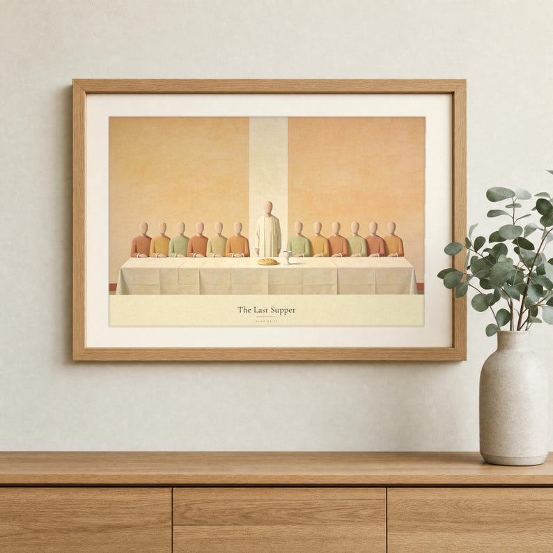 The Last Supper wall art in a light oak landscape frame hung above a cream linen sofa, terracotta vase with dried olive branches on a walnut console, warm plaster wall and soft afternoon daylight. Thirteen abstract faceless figures in terracotta, cream and olive earth tones share one long table. Modern Christian living room decor, Luke 22:19 printable download from TheFramedVerse on Etsy.