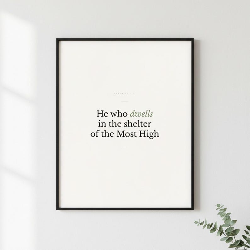 Psalm 91:1 Wall Art He Who Dwells in the Shelter of the Most High Minimalist Scr — lifestyle mockup in modern room setting with elegant framed print on wall. This modern minimalist christian scripture wall art print features beautiful serif typography on warm cream background. Psalm 91:1 bible verse digital download printable for home office bedroom living room gallery wall decor. Perfect chris...