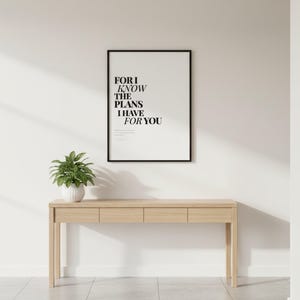 Jeremiah 29:11 Wall Art For I Know the Plans I Have for You Modern Christian, in contemporary bold serif typography in black on clean white background, styled on a wooden floating shelf next to a ceramic vase with dried eucalyptus, creating a warm and inviting Christian home decor vignette