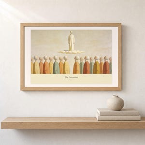 Shelf mockup of The Ascension in a light oak frame resting on a pale wood surface beside stacked neutral books and a rounded ceramic vase. The framed print shows Christ standing in light above a soft cloud while gathered witnesses look upward. Cream matting, soft wall texture, and natural light present the horizontal Bible artwork at an easy domestic scale.