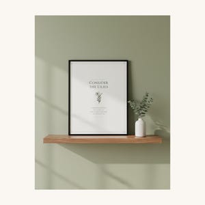 Consider the Lilies Matthew 6 28 framed Scripture Print on shelf in christian home, sage green aesthetic decor, sermon on the mount botanical bible verse poster, aesthetic christian floral scripture printable