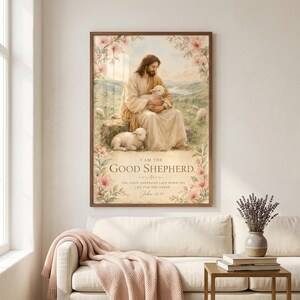 I Am The Good Shepherd John 10:11 watercolor wall art print displayed in walnut wood frame above a cream linen sofa in a sunlit Christian family living room with dried lavender, brass side table, and blush throw blanket. Perfect baptism gift, christian nursery decor, faith home wall art for the modern Christian home. Digital download instant access.