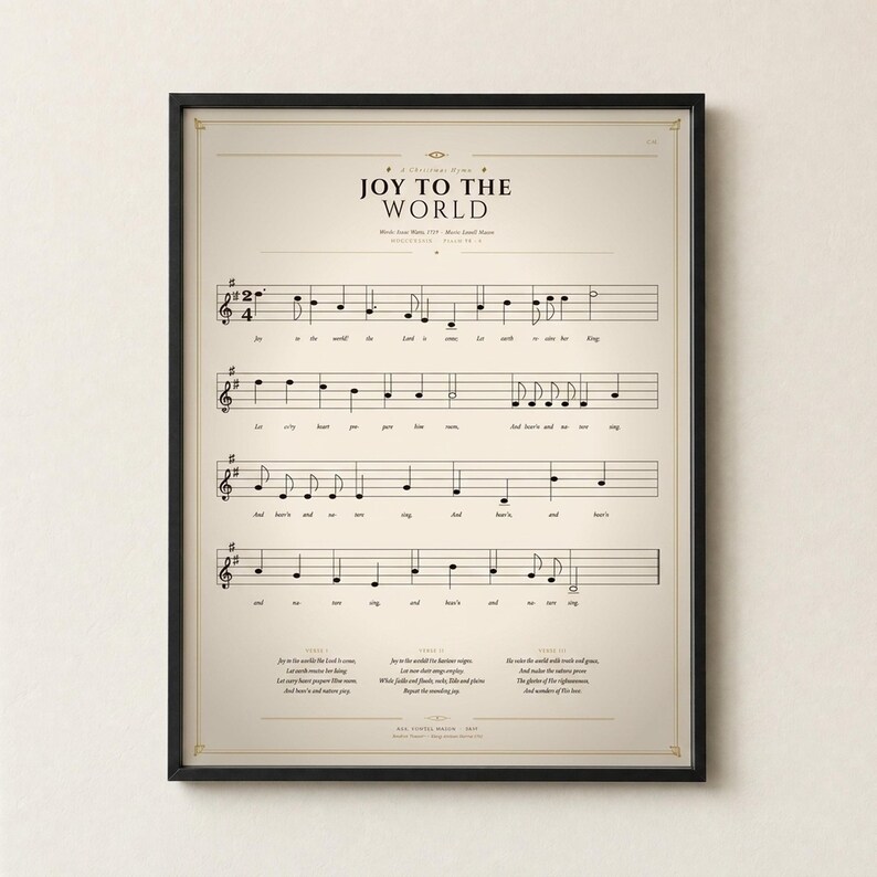Joy to the World single vintage hymn print in a thin black metal frame, frontal view on an off-white textured wall, modern classical Christmas arrangement with soft top light and gentle shadow. Holiday Christian sheet music wall art digital download from TheFramedVerse, Psalm 98:4 hymnal page in cream and antique sepia.