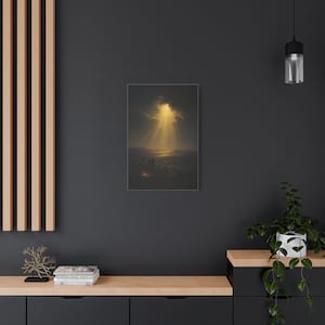 Shepherds and their flock rest beside a glowing nighttime campfire as heavenly light breaks through clouds over distant Bethlehem. The dark vintage oil painting renders the illuminated hills in deep blue, brown, and gold with a peaceful, reverent mood. This Luke 2:14 Christmas wall art is printed on stretched canvas. An alternate angle provides a product view of the wrapped canvas construction.