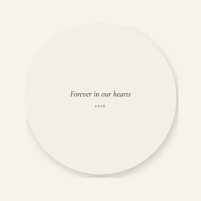 Back product card showing the reverse side of the double sided First Christmas in Heaven ornament against a warm cream background. The round acrylic keepsake displays the message Forever in our hearts in elegant script with the year 2026 below. A soft shadow and clean presentation make the coordinated back design and smooth circular shape easy to see.