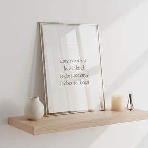 Christian Wedding Wall Art Set of 3 Bible Verse Prints Love Is Patient, — "Love is patient, love is kind. It does not envy, it does not boast", in romantic wedding typography with elegant calligraphy, delicate gold ornamental accents on warm blush background, presented as an elegant flat lay on white marble surface alongside a fountain pen and fresh eucalyptus sprig