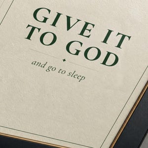 Close-up of Give It To God print on archival matte paper. Sharp dark forest green serif on warm cream. 300 DPI christian bedroom wall art printable by TheFramedVerse.