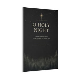 Shadowy evergreens border elegant cream O Holy Night serif lettering on textured charcoal paper, surrounded by scattered golden stars. This dark vintage black, cream, and gold design draws on the beloved Christmas carol and Luke 2:11. The dramatic typography artwork is printed on stretched canvas. This close product view highlights the printed surface and finished edges.