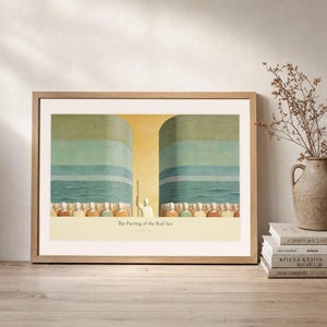Leaning frame mockup of The Parting of the Red Sea on a rustic wood console beside stacked art books and a tall ceramic vessel with dried stems. The print shows Moses on the centre axis between two towering walls of water while the people cross the dry seabed. The oak frame, broad cream mat, plaster wall, and soft side light create a relaxed display while keeping the title and Exodus 14:21 legible.