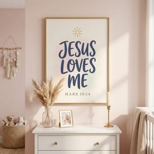 Jesus Loves Me Mark 10:14 bible verse print styled in pastel pink girls nursery with white dresser, dried pampas grass, and brass candle. Modern hand-lettered script with gold accents — part of Kids Christian wall art set of 6. Perfect girls room decor, baby girl baptism gift, baby shower gift, christian nursery.