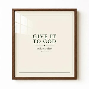 Give It To God and Go To Sleep christian print in walnut frame, studio shot on white. Bold dark green serif on cream. Bedroom scripture wall art instant download by TheFramedVerse.