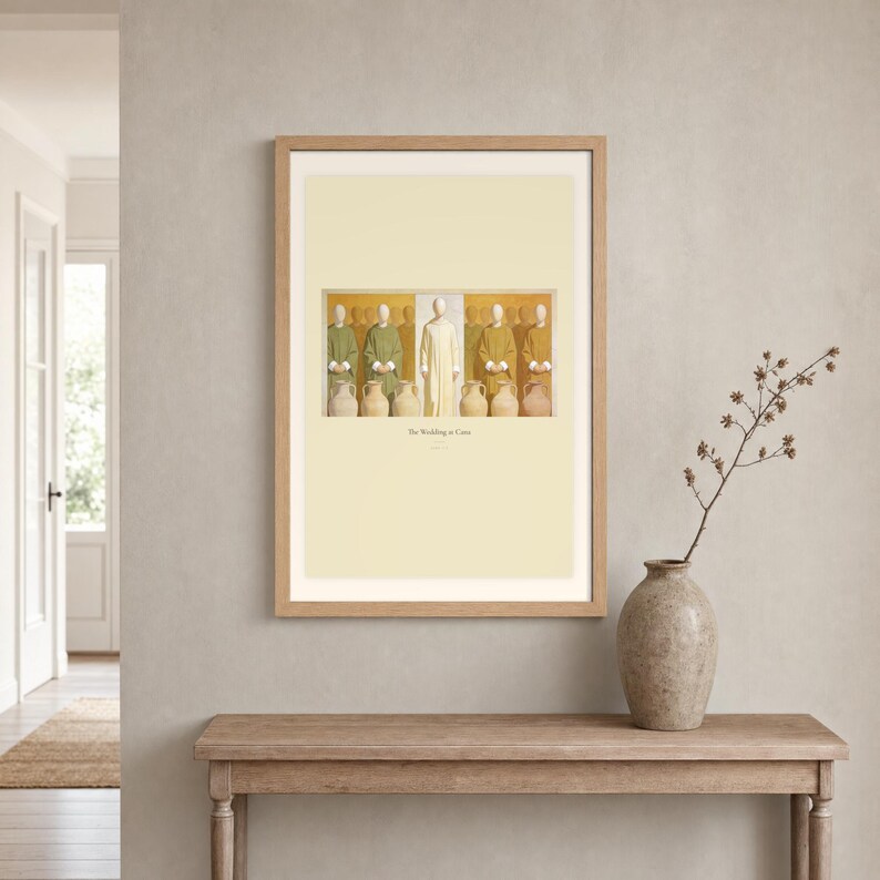 Room mockup of The Wedding at Cana displayed in a light oak frame on a warm neutral wall. The landscape artwork shows Christ centered between six complete stone jars, with three on the left and three on the right. A wide cream mat and restrained fresco palette suit a calm living room, prayer space, or Christian home. The printed title and John 2:7 remain visible beneath the image.