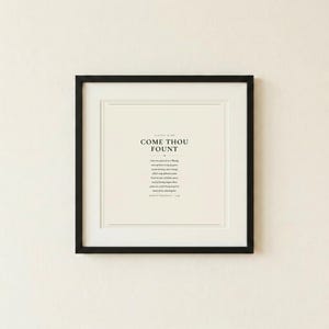 Come Thou Fount of Every Blessing hymn lyric scripture art print in thin black frame on warm cream textured wall, front-facing clean product photo, dark forest green minimalist typography on cream background, christian hymn wall art song lyric art print baptism gift confirmation gift first communion