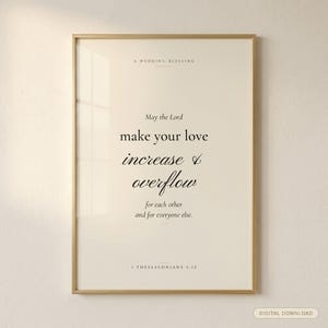 1 Thessalonians 3:12 modern Christian wedding wall art print in solid walnut frame, frontal studio shot on cream backdrop with soft top-left key light, glass reflection visible, e-commerce hero photograph, couple scripture digital download, Bible verse wedding gift by TheFramedVerse